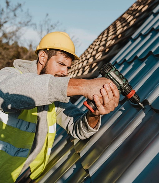 side-view-man-working-roof-with-drill